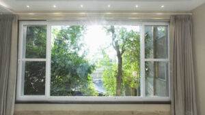 A room with a large window and curtains.