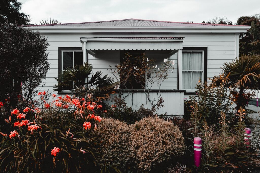 facade of cottage with many plants on garden bed 2025 04 04 00 10 31 utc