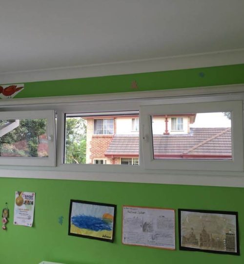 A child's room with green walls and a window.