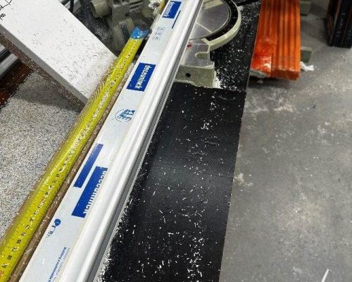 A person is using a saw to cut a piece of wood. A person is using a saw to cut a piece of wood.
