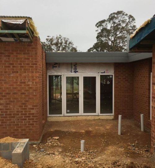 UPVC French & Single Hinge Doors 3 A building under construction with UPVC French & Single Hinge doors.