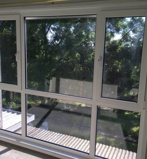 A window in a room with a view of trees.