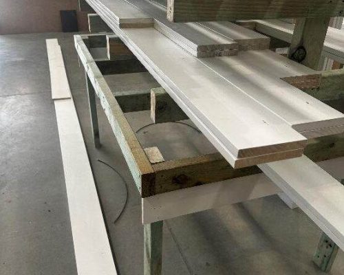 A white sheet of plywood on a table in a factory. A white sheet of plywood on a table in a factory.