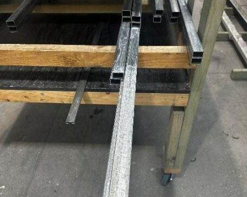 Steel beams on a pallet in a warehouse. Steel beams on a pallet in a warehouse.