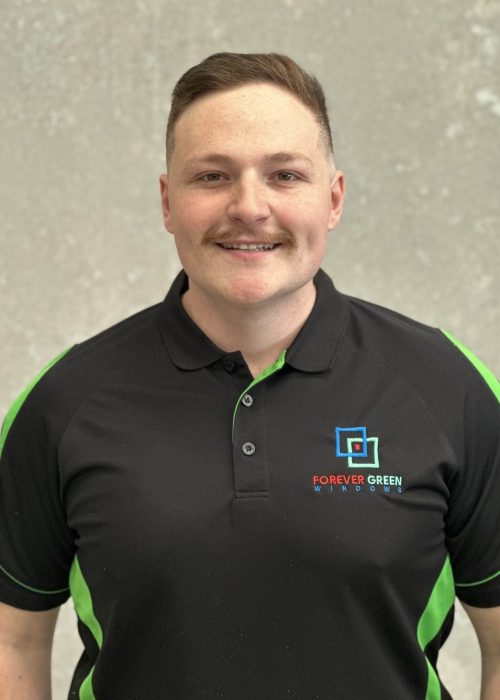 A man wearing a black and green polo shirt.