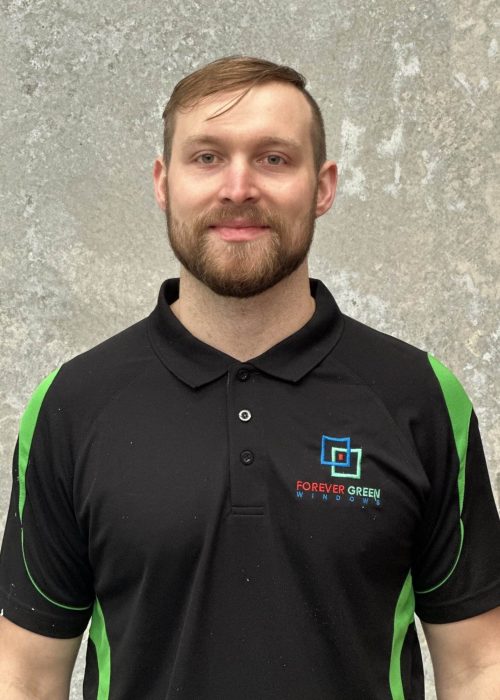 A man wearing a black and green polo shirt.