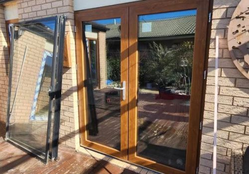 A UPVC French door with a glass window on a deck.