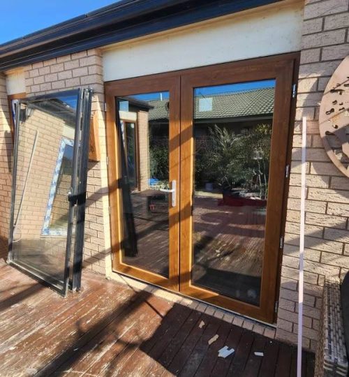 UPVC French & Single Hinge Doors 1 A UPVC French door with a glass window on a deck.