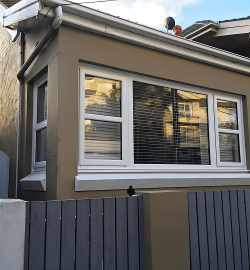 A house with windows and a fence.